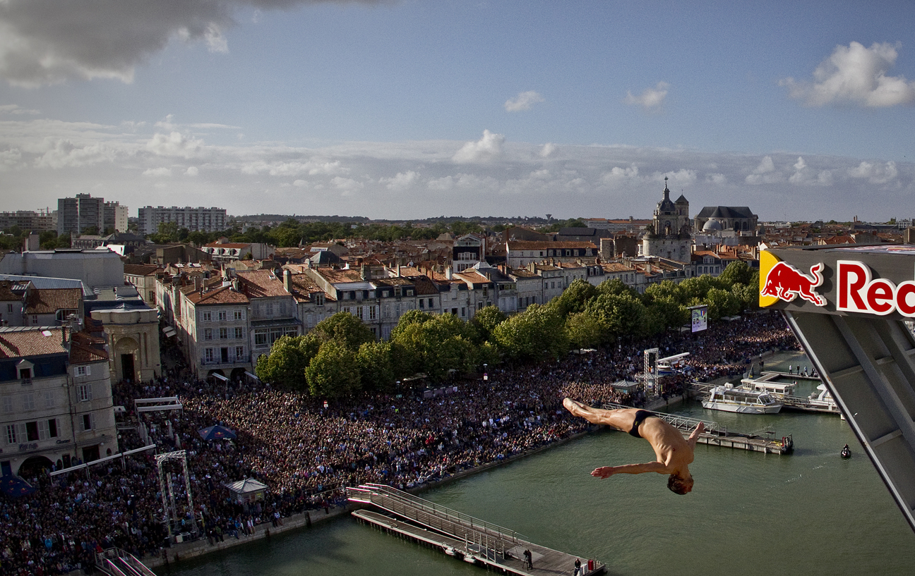 Cyrille Oumedjkane of France dives from the 27.5 metre platform at the fourth stop of the Red Bull Cliff Diving World Series at La Rochelle, France on June 18th 2011. Photo: Romina Amato / Red Bull