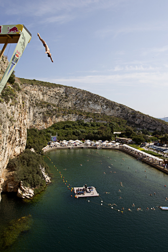 Sasha Kutsenko of Ukraine dives from the 26.8 metre platform during the second training session prior to the third stop of the Red Bull Cliff Diving World Series at Lake Vouliagmeni in Athens, Greece on May 21st 2011.