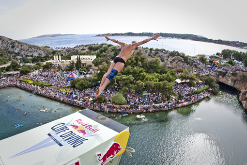 Artem Silchenko of Russia dives from the 26.8 metre platform during the third stop of the Red Bull Cliff Diving World Series at Lake Vouliagmeni in Athens, Greece on May 22nd 2011.