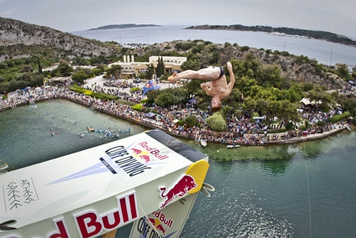 Alain Kohl of Luxembourg dives from the 26.8 metre platform during the third stop of the Red Bull Cliff Diving World Series at Lake Vouliagmeni in Athens, Greece on May 22nd 2011.