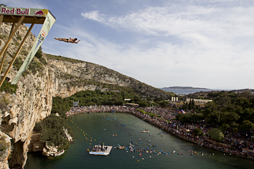 Sacha Kutsenko of Ukraine dives from the 26.8 metre platform during the third stop of the Red Bull Cliff Diving World Series at Lake Vouliagmeni in Athens, Greece on May 22nd 2011.