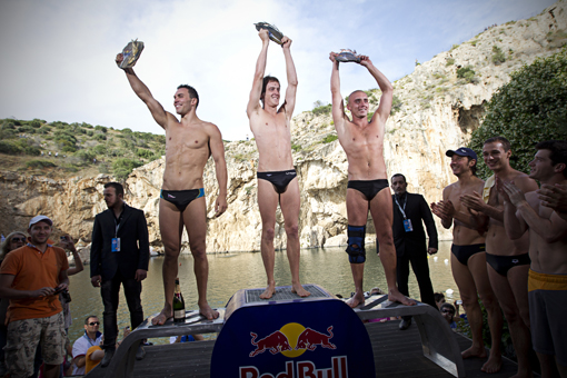 (L to R) Michal Navratil of Czech Republic, Gary Hunt of Great Britan and Artem Silchenko of Russia celebrate during the third stop of the Red Bull Cliff Diving World Series at Lake Vouliagmeni in Athens, Greece on May 22nd 2011.