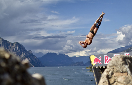 Artem Sichenko of Russia dives from the 27 metre platform on Scaliger Castle during the second training session of the fifth stop of the Red Bull Cliff Diving World Series, Malcesine, Italy on July 23rd 2011.